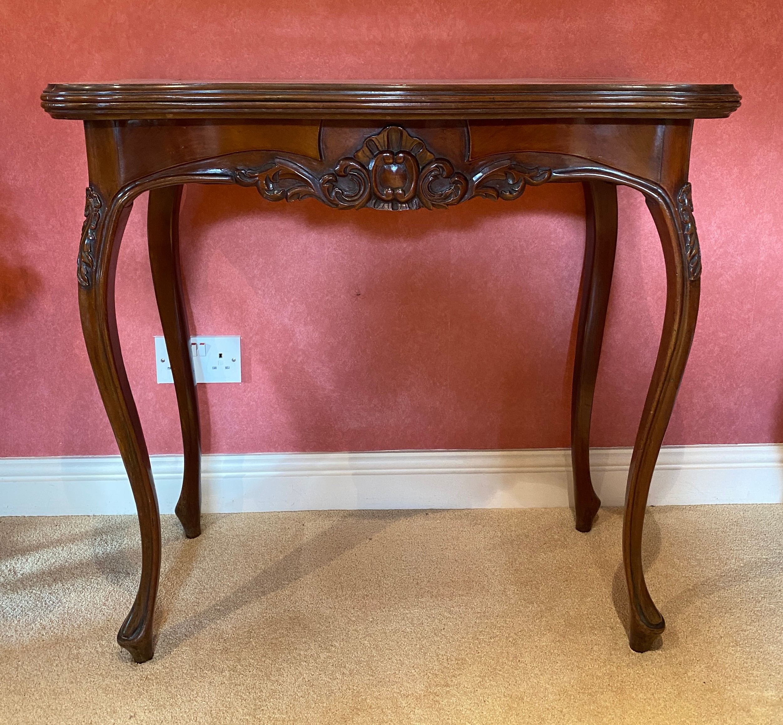 A continental mahogany carved card table with pull out drawer to support top. 82 w x 41.5 d x 77.5cm