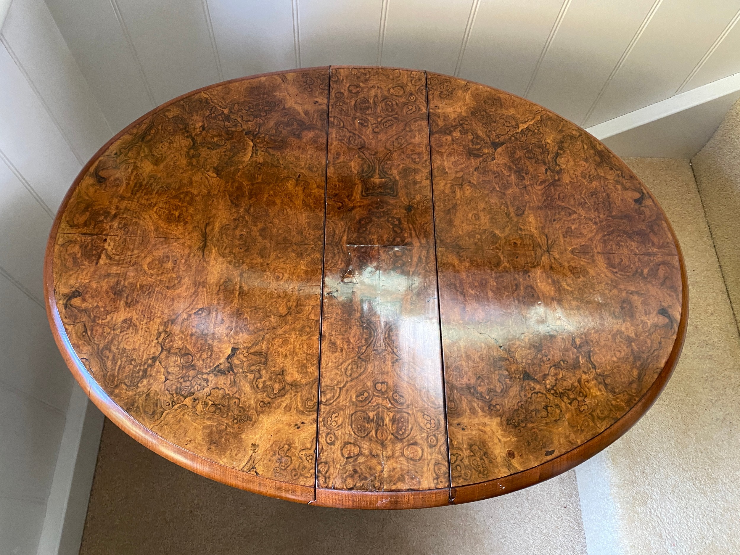 A 19thC burr walnut oval drop leaf table on white porcelain castors. Open 70 x 53 x 53cm h. Closed - Image 3 of 4