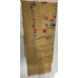 A mid 20thC cream silk embroidered shawl, decorated with flowers, knotted fringe, approx. 165 x 55cm