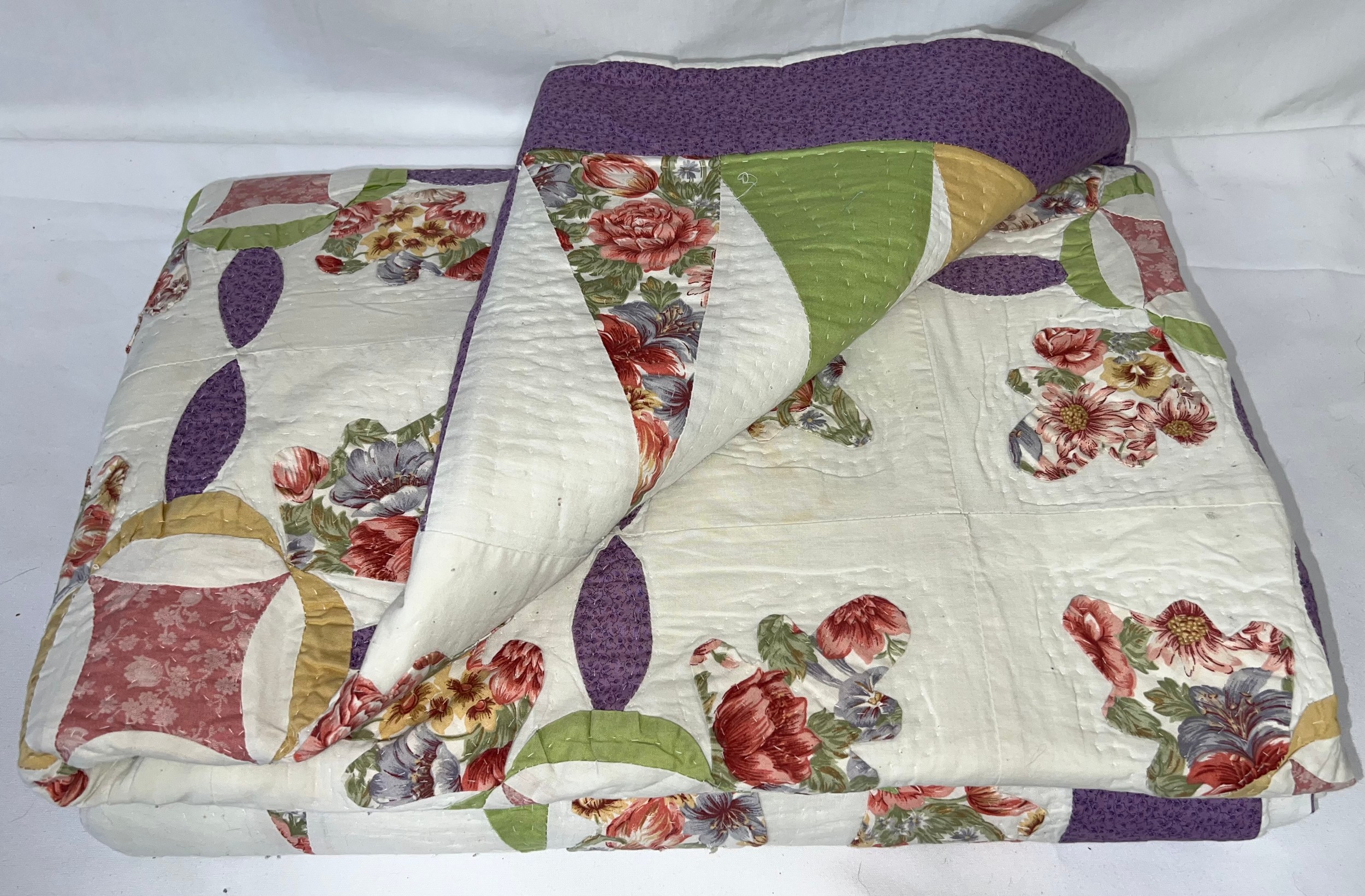 A handmade patchwork quilt. Approx 470 l x 430 w.