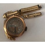 A 9ct gold cased ladies wristwatch with a rolled gold strap. Total weight 13.6gm.