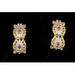 A pair of fourteen carat gold earrings for pierced ears set with pink gem stones. Total weight 6.