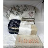 A suitcase full of linen to include tray and table cloths, pillow cases, napkins, doilies,