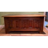 A carved oak coffer with carvings to front and sides. 113 w x 51 h x 46cm d.