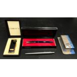 A boxed Comoy's black and gold coloured lighter initialled B.P.G. along with a boxed Parker fountain