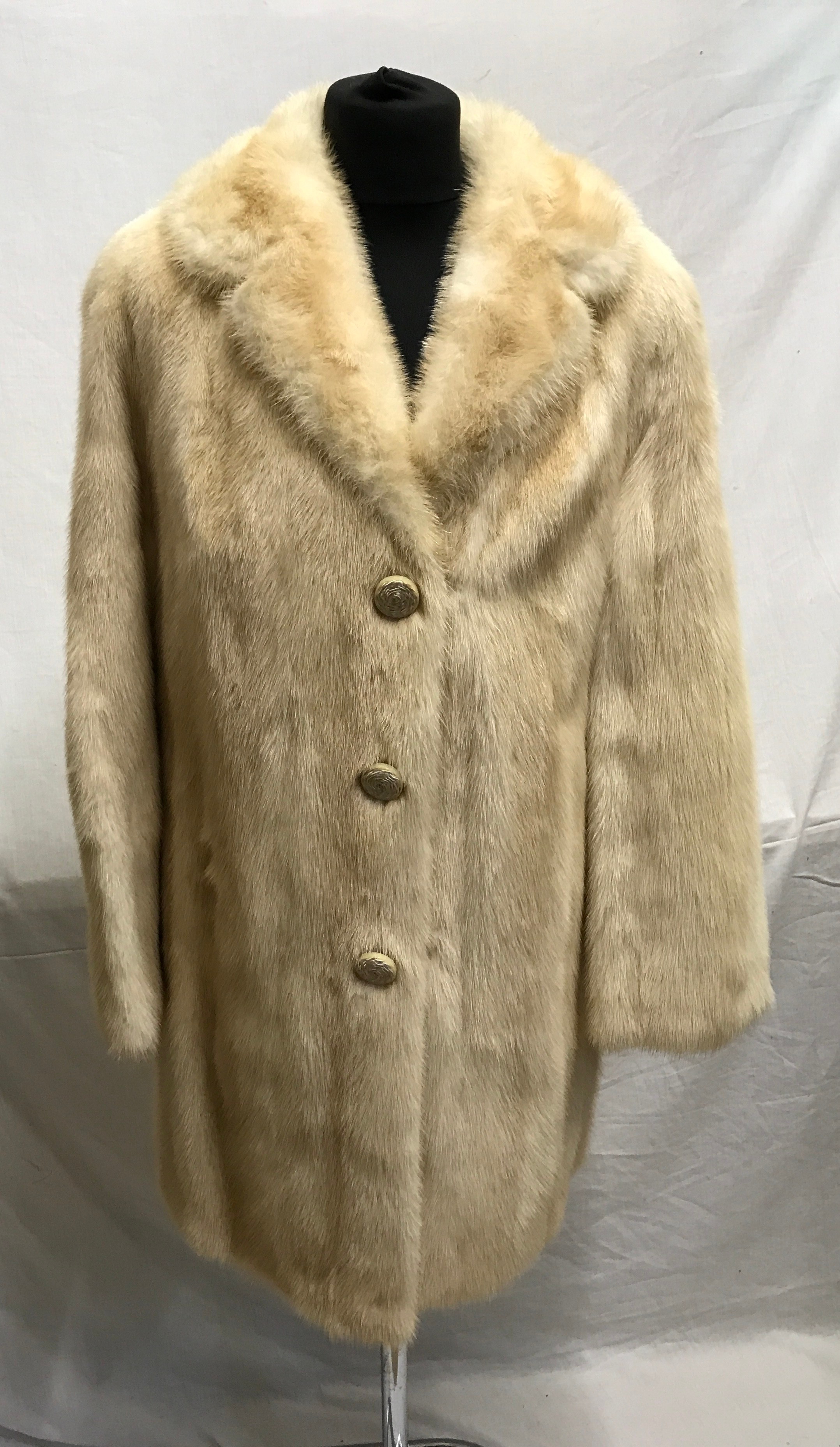 A cream mid-length mink coat with 2 x hook and eye fastenings and curved lapel. Embroidered initials