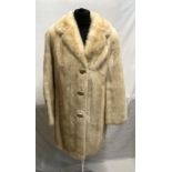 A cream mid-length mink coat with 2 x hook and eye fastenings and curved lapel. Embroidered initials