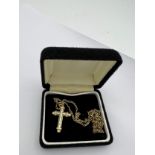 Fourteen carat white and yellow gold crucifix set with diamonds on a 9 carat yellow gold chain.