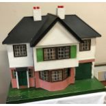 A Triang Dolls House circa 1935 77 x 44cm with furniture to each room.