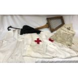 Red cross items to include three nurses' uniforms, three handkerchiefs, a practice sling along