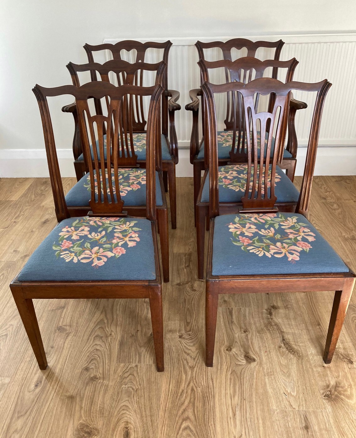 A set of six mahogany dining chairs to include 2 carvers with needlework drop in seat covers.