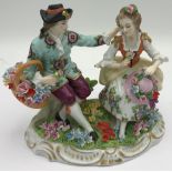 A Sitzendorf figure of a couple sitting together with flowers