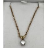 Diamond drop pendant set in 18 carat gold on 9 carat gold chain, 40cm long.