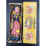A vintage Pelham puppet in the form of a Dutch girl with box.