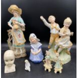 A collection of bisque figures, some in the style of Gebruder Heubach to include a pair of