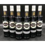 Six 500 millilitre bottles of Crème de Cassis. Label on bottle "International Spirits Challenge 2015