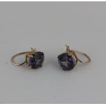 A pair of purple stone earrings, set in yellow gold