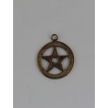 A 9ct gold Masonic pendant medallion in the form of a star within a circle, 2.9g 2cm