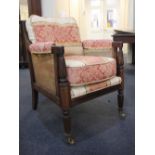 A 19th century bergere library chair, with rectangular rattan back and reeded down swept arms
