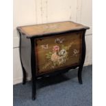 A modern painted commode with floral and gold coloured decoration, the serpentine top above three