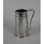 A Tiffany & Co sterling silver cream jug tapered cylindrical form with hammered decoration,