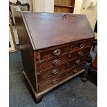 A George III mahogany bureau, fall front enclosing a fitted interior with drawers, cupboard and
