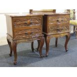 A pair of French style carved mahogany bedside chests, each with serpentine top and two drawers on