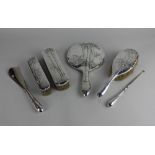 A sterling silver six piece dressing table set of three various brushes, hand mirror, shoe horn