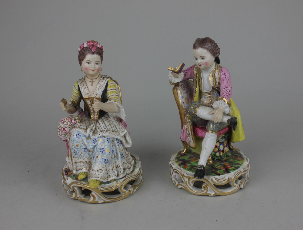 A pair of Meissen style porcelain figures of a gentleman reading and a lady sewing 14cm high (a/f)
