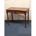 A Victorian carved mahogany tea table with rectangular fold-over top, on turned legs 91cm
