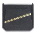 An 18ct gold tie clip with single diamond centre