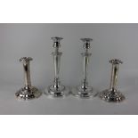 A pair of silver plated candlesticks baluster shape with urn sconces and removable drip trays,