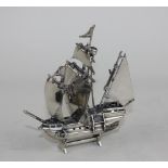 A white metal possibly Italian model of galleon with sails, flags, crowsnest and other details,