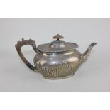 A Victorian silver teapot oval shape with demi-reeding and gadrooned border, engraved armorial,