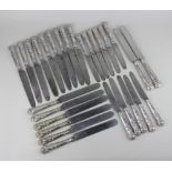 A set of nine George IV Kings pattern silver dinner knives and twelve dessert knives with steel