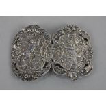 A Victorian nurses silver belt buckle in two pierced oval sections embossed with cherubs and