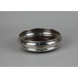 A modern silver bottle coaster with turned wood base, maker Broadway and Co. Birmingham 1979, 14cm