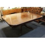 A Regency mahogany pedestal dining table the rectangular crossbanded top with moulded edge and