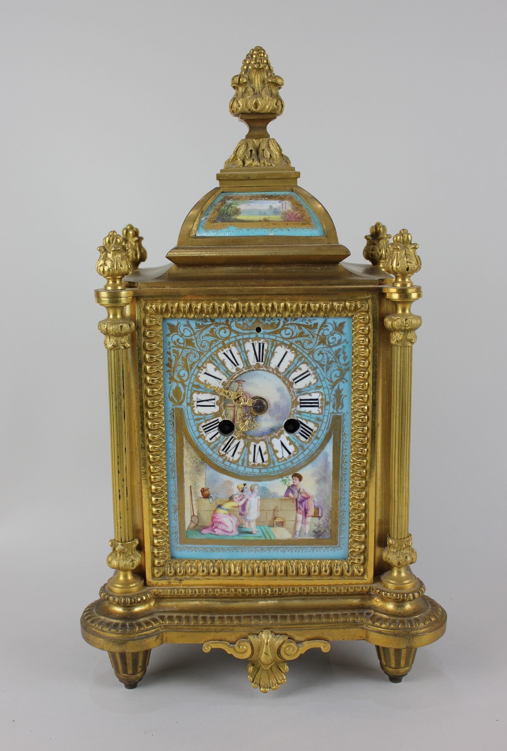 A 19th century ormolu mantle clock having eight-day French movement with Sevres style panels and