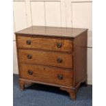 A 19th century oak chest of three drawers with moulded edge top, brass drop ring handles, on bracket