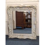 A large gilt and white painted rectangular wall mirror, with scrolling floral and foliate