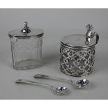 A George III silver lidded glass mustard pot oval facetted form with silver mount and domed lid