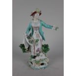 A Derby style porcelain figure of a flower seller with encrusted floral decoration and a lamb at her