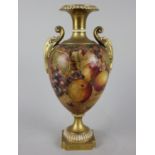 A Royal Worcester porcelain vase by C Hughes baluster shape with twin gilt scroll handles, decorated