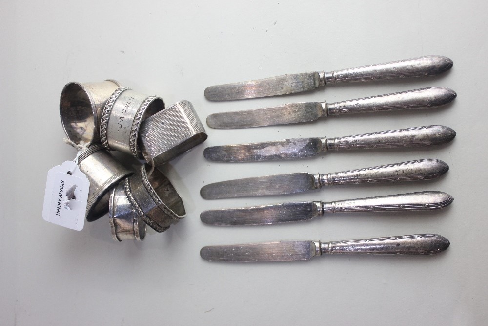 Six various silver napkin rings 4.6oz and a set of six silver handled dessert knives,Sheffield 1918