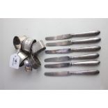 Six various silver napkin rings 4.6oz and a set of six silver handled dessert knives,Sheffield 1918