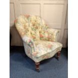 A Victorian button upholstered armchair, re-upholstered in pink and yellow floral fabric decorated
