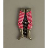 A German novelty folding ladies legs pocket corkscrew with red and white striped stockings marked '