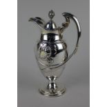 A late Victorian Art Nouveau silver claret jug baluster form with hinged lid and bud finial