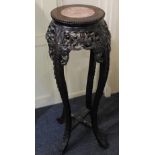 A Chinese carved hardwood jardiniere stand the circular marble inset top with moulded edge above a
